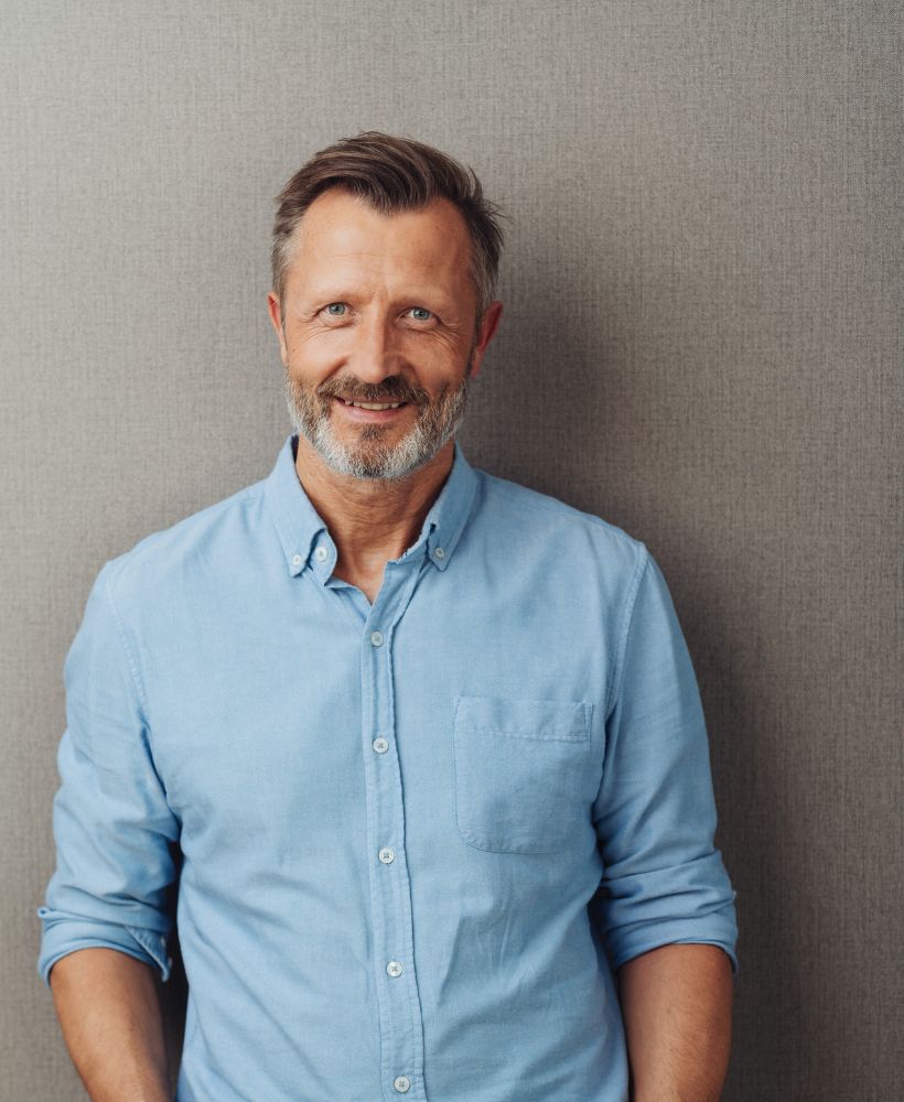 smiling man in button down shirt